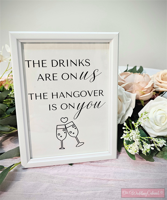 5"x7" White Frame "The Drinks Are On Us" Sign
