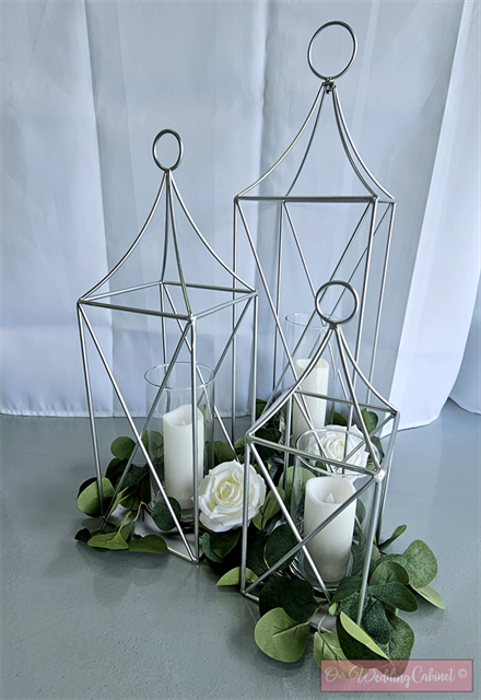 Set of 3 Metal Lanterns, Silver: each set will get a 24",19",13" Lantern with eucalyptus candle rings that will fit glass vases. **VASES WILL NEED TO BE ADDED SEPERATELY, 6.25",7.5",9"**