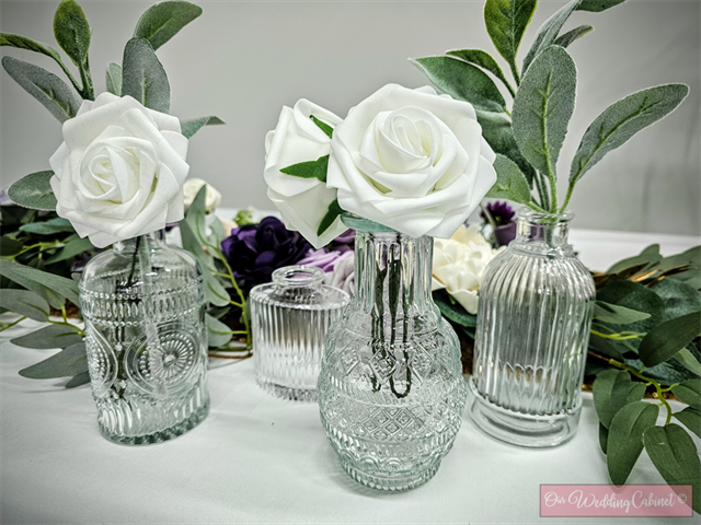 Assortment of Textured Clear Bud Vases (these will be different shapes and sizes) **THESE MUST BE RETURNED DRY OR YOU WILL BE CHARGED A CLEANING FEE**